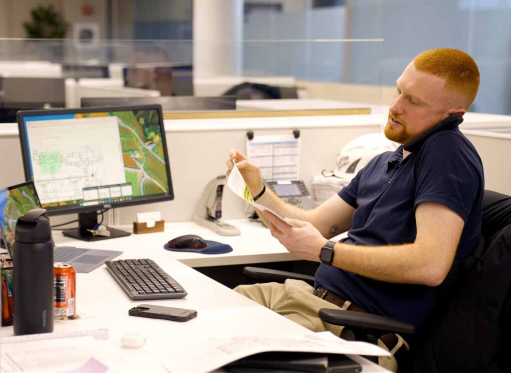 henick employee working and talking on phone