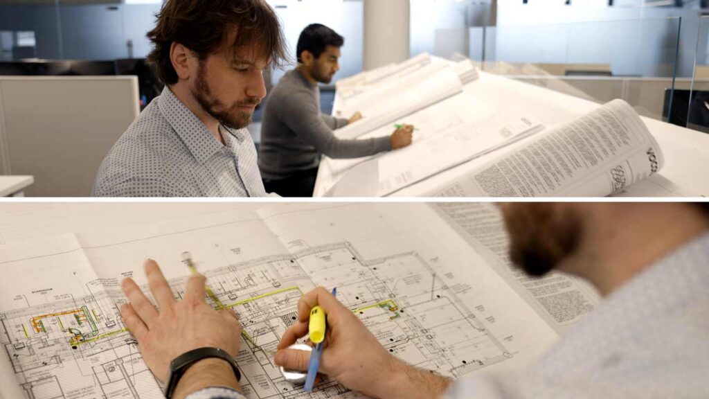two henick lane employees drafting hvac plans